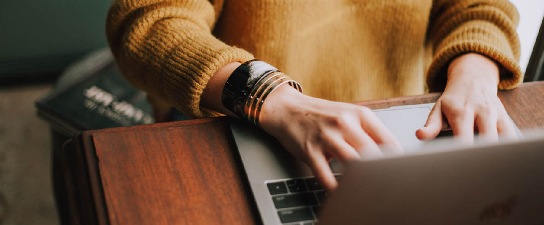 Person typing on a laptop keyboard