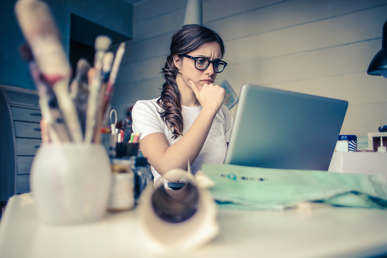 woman thinking with laptop